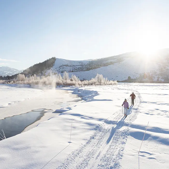 Couple on Jackson Hole Cross-Country Ski Tour Along the Snake River in the Sun